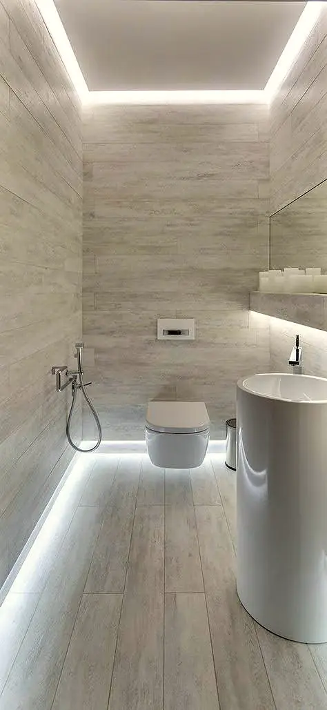 Bathroom with large-format wall tiles, wall-hung toilet and hidden cove lighting